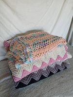 Stacked view of all three crocheted quilts