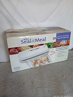 Front of boxed Rival Seal a Meal vacuum sealer
