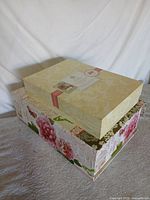 Two decorative storage boxes stacked