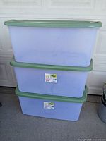 Three stacked Sterilite storage totes showing full view