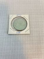 Front of coin in holder showing voyageur canoe design and 1979 date
