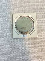 Obverse view of 1986 Canadian one-dollar coin in holder