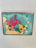 Front of sealed 13-coin set on Canada map card