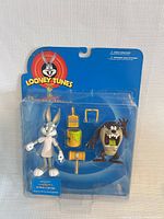 Front view of sealed Looney Tunes action figure two-pack showing figures and accessories