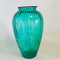 full front view of turquoise ribbed glass vase