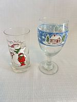 Both Holly Hobbie tumbler and Libbey Winter Village wine glass side by side