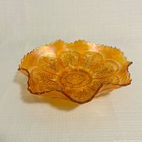 Oblique view of marigold carnival glass ruffled bowl