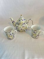 Teapot front with two cups