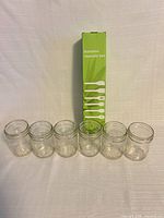 Group shot showing six jars and boxed utensil set