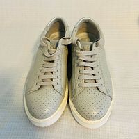 Top view of both sneakers showing perforated leather and laces
