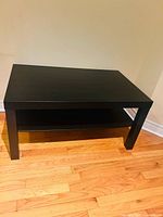 IKEA Lack coffee table front view showing legs and lower shelf