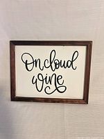 Front view of framed sign showing text and frame