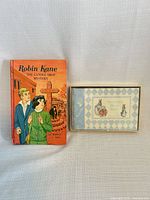 Robin Kane book standing beside Beatrix Potter photo album boxed