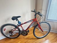 Full side view of red Supercycle 1800 kids mountain bike.