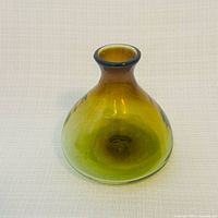Front view of olive-amber hand-blown glass vessel
