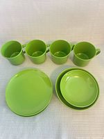 Front view of 4 cups, stacked plates and bowls