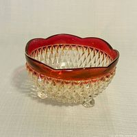 Overall view of clear diamond point footed bowl with ruby rim