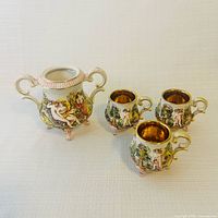 Group shot of sugar bowl and three demitasse cups