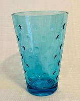 Front view of Capri blue polka dot glass vase