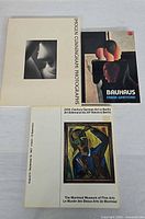 Front covers of the three books arranged on table