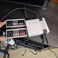 Console and two controllers connected, cables visible