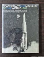 Front cover with dust jacket showing title, authors, publication year and rocket image