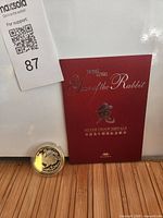 Medal in capsule with burgundy presentation folder