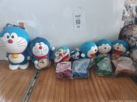 Group shot of six loose Doraemon figures and four sealed Happy Meal toys