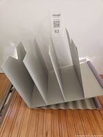 Angled view of 5-slot metal file sorter on bamboo surface