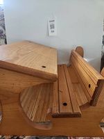 Angled view of wood foot rest showing top platform and lower slatted section