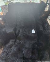 Overall view of dark brown fur rug