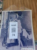 Full view of the photograph in plastic sleeve with label