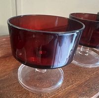Close-up of single ruby red dessert cup on clear base