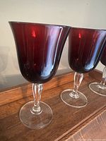 Two Luminarc ruby red wine glasses showing bowl color and stem design