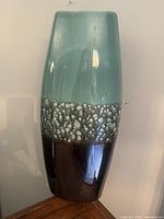 Front view of tall porcelain vase showing full gradient and textured glaze band