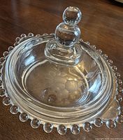 Top view of covered dish showing finial and etched cornflower design