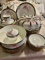 Overall view of stacked dinnerware set showing plates, cups, saucers, serving pieces