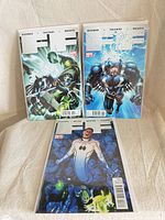 Front view of all three bagged FF comics issues 7, 6, 3