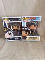 Both boxed Funko Pop figures side by side