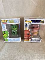 Both boxed Funko Pop figures front view