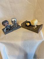 Front view of both diorama sets showing figures and bases