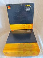 Front view of both Kodak Carousel Transvue slide tray boxes, 80 and 140 capacities
