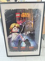 Full view of framed poster leaning against wall