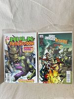 Both bagged single-issue comics side by side