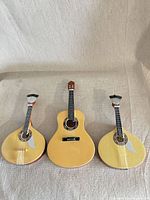 Front view of all three miniature guitars