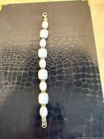 Full view of sterling silver opal bracelet laid flat