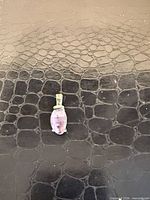 Front view of sterling silver pendant with purple oval cabochon stone