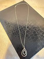 Full view of sterling silver necklace with teardrop pendant