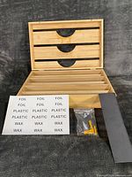 Organizer box open showing six slots, accessories displayed