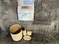 Full lot showing packaged shower curtain, metal caddy, waste bin, soap dispenser, tumbler holder, soap dish